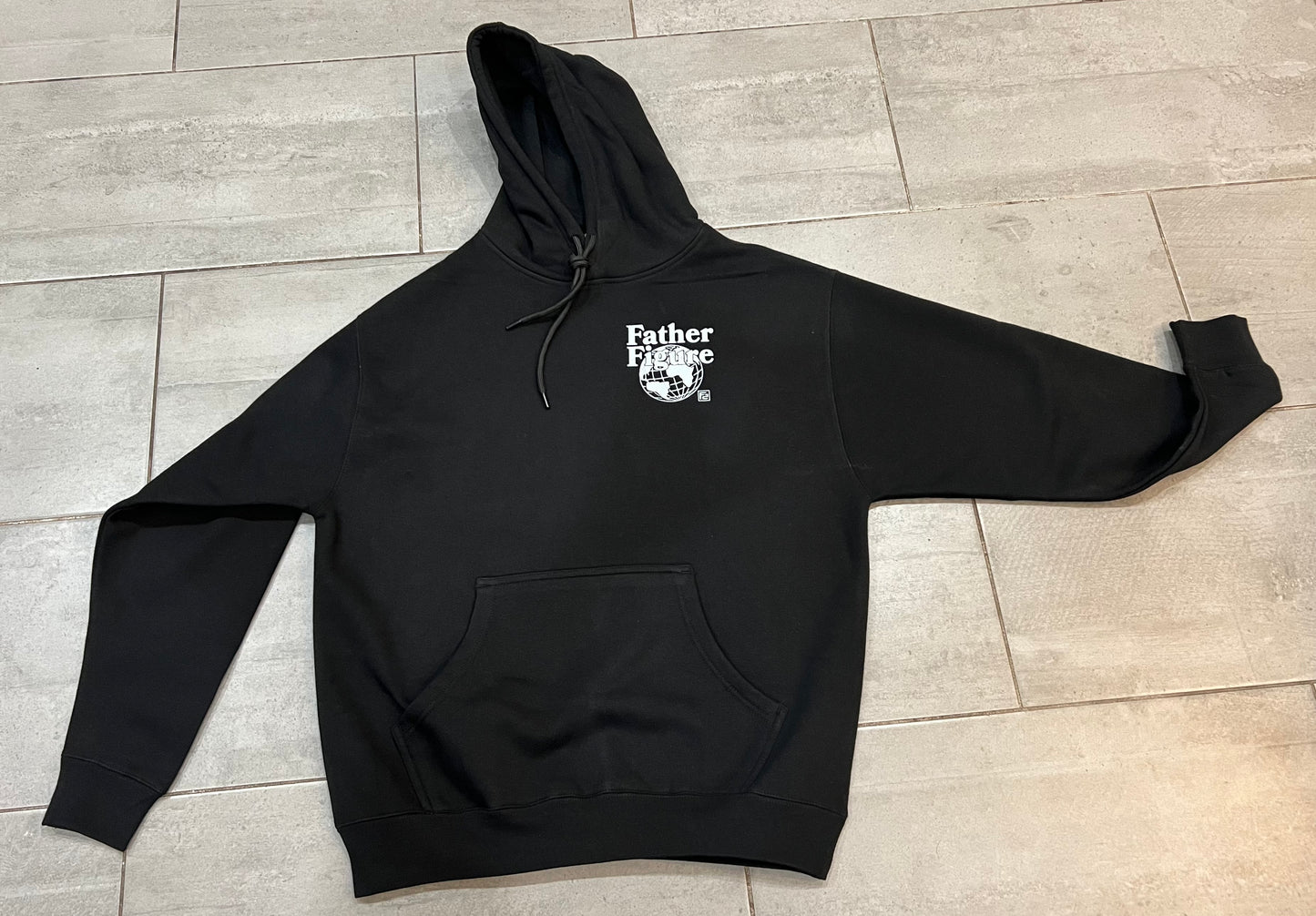 Cozy black Father Figure Hoodie with a bold logo, embodying strength and style for casual, everyday wear.