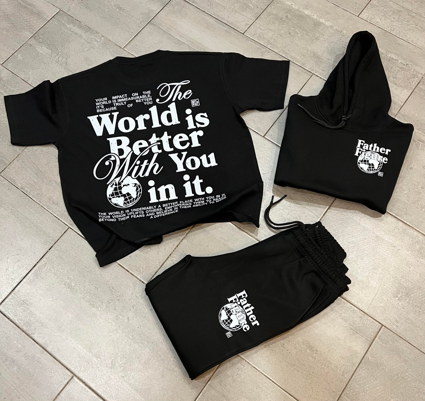 Stylish Father Figure Combo Set featuring a black hoodie, joggers, and a free t-shirt, all with bold, empowering logos.
