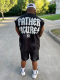 Owner, Reggie George wearing a black sleeveless jacket with 'FATHER FIGURES' text on the back, standing outdoors.