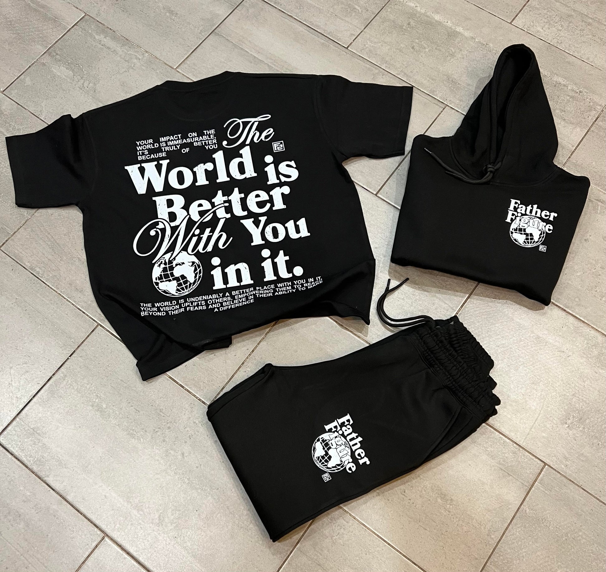 Stylish Father Figure Combo Set featuring a black hoodie, joggers, and a free t-shirt, all with bold, empowering logos.